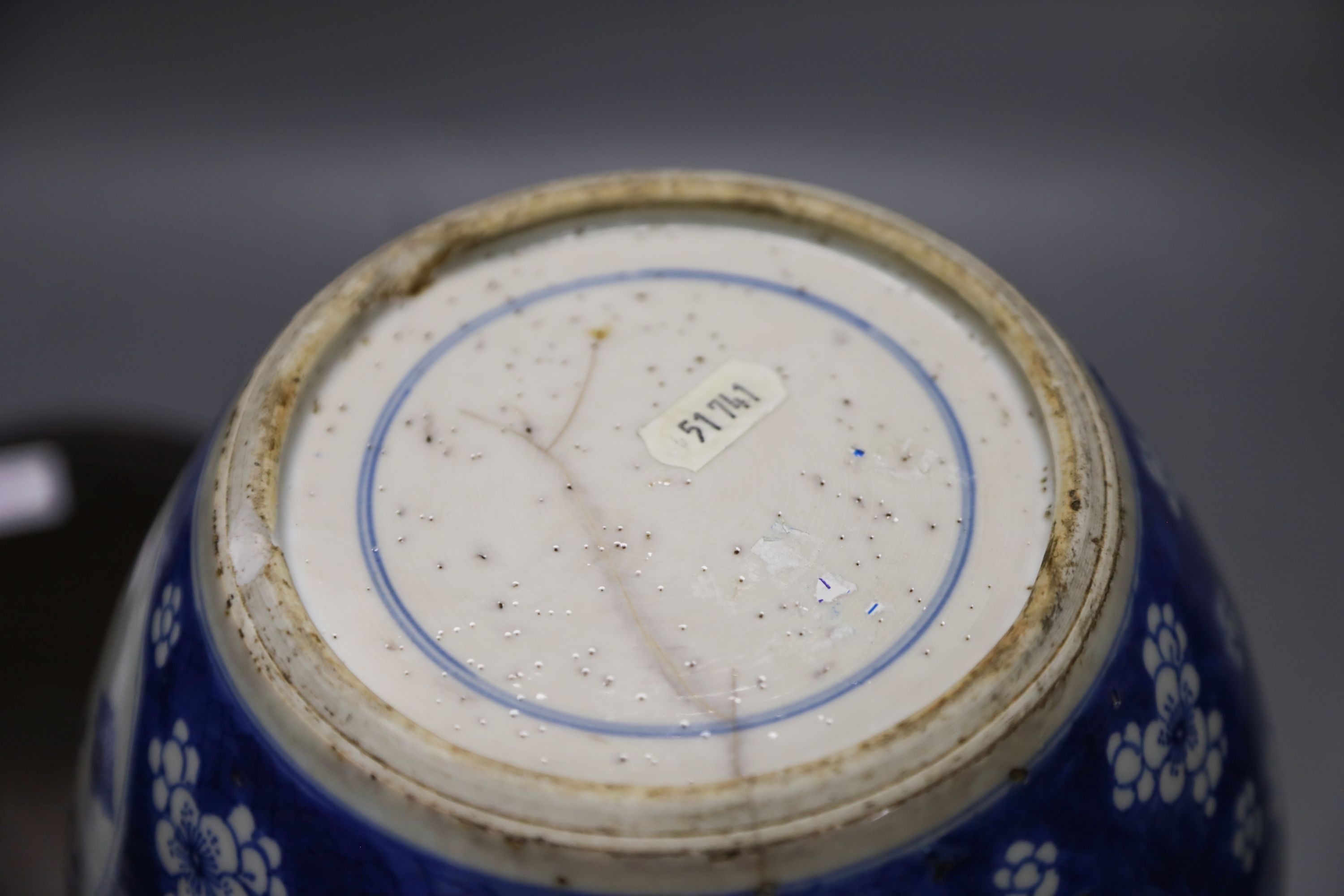 A Chinese Kangxi blue and white hundred antiques jar, 21cm, cracked, with hardwood stand and a Samson powder blue jar, 26cm, wear